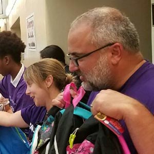 Board Members giving away sneakers to kids.